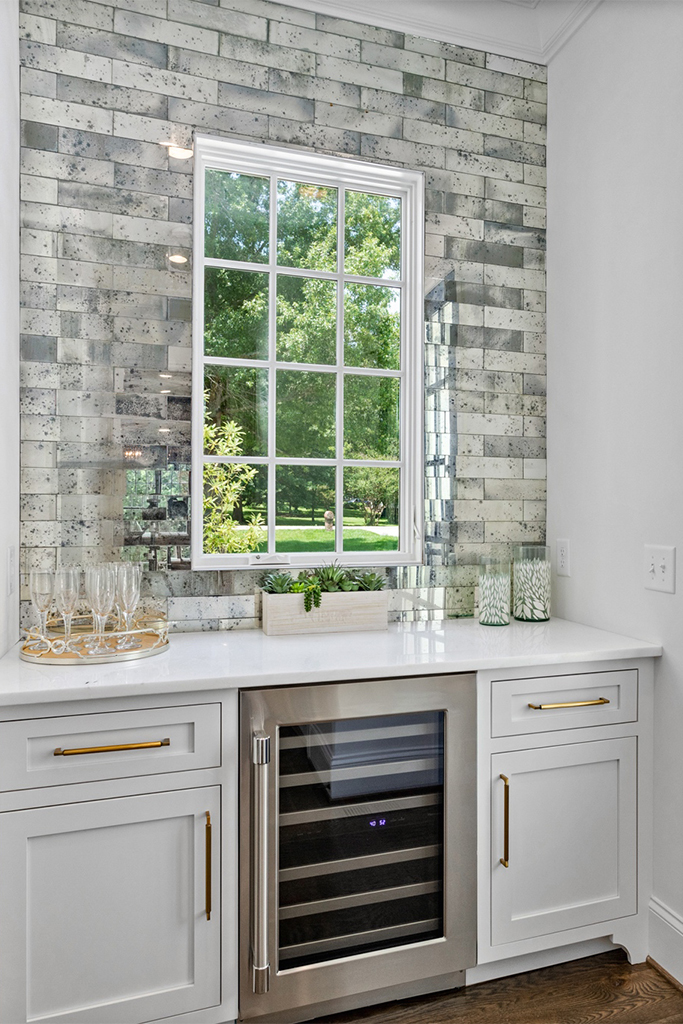 Gorgeous wet bar with mini fridge overlooking scenic backyard